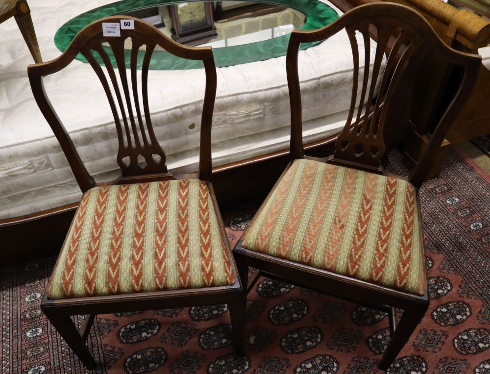 A set of four Hepplewhite style dining chairs (3 single, 1 arm) and four Edwardian dining chairs